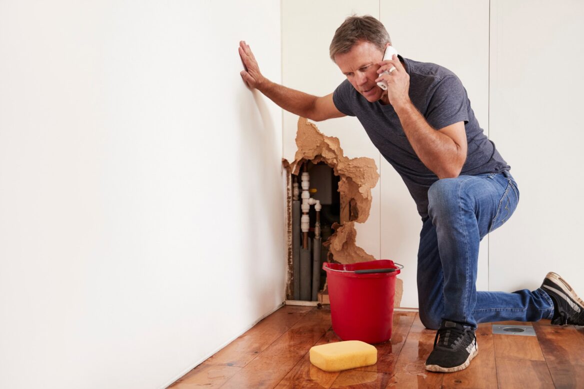 Burst pipes plumbing emergency man on phone