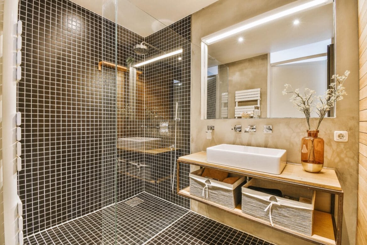 Modern bathroom tiled throughout with rain shower