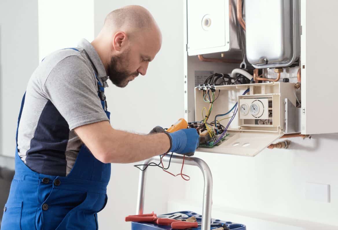 Plumber Servicing Gas Boiler Control Board